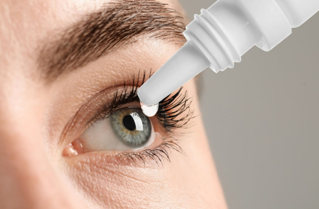 Close up of a woman's eye as a drop of artificial tears enters it for her dry eye treatment.